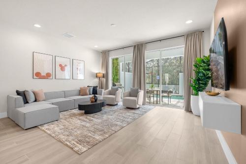 a living room with a couch and a table at Upstay - Modern Family Townhouse w Private Pool in Orlando