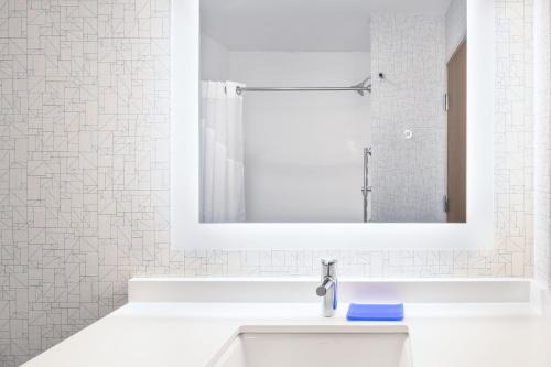 a white bathroom with a sink and a mirror at Holiday Inn Express & Suites - Gilbert - East Mesa by IHG in Gilbert