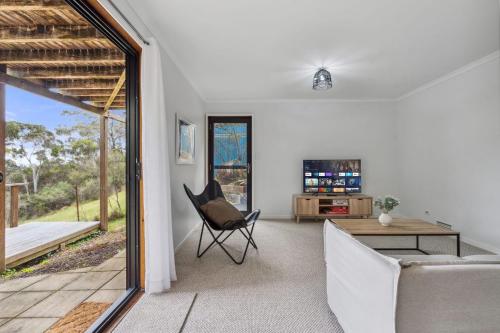 a living room with a couch and a table at Charming 4 Bed Home in Mount Victoria in Mount Victoria