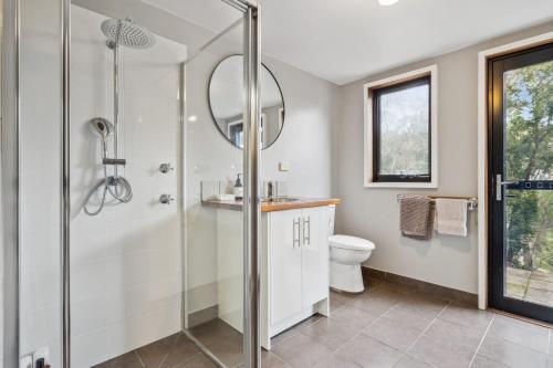 a bathroom with a shower and a toilet at Charming 4 Bed Home in Mount Victoria in Mount Victoria