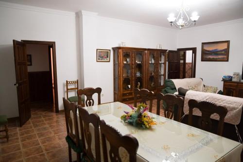 a living room with a dining table and chairs at Casa Rural LA ENCINA in Hornachuelos