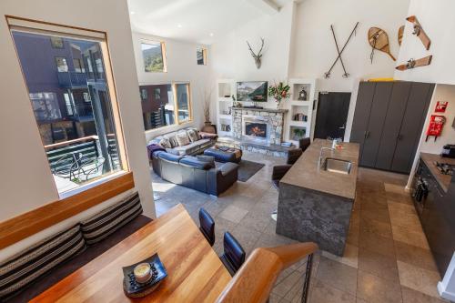 a living room with a couch and a fireplace at Powder 2B - Thredbo in Thredbo