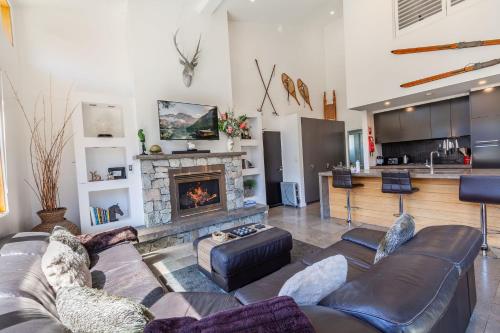 a living room with a couch and a fireplace at Powder 2B - Thredbo in Thredbo