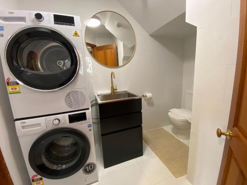 a bathroom with a washing machine and a sink at Bollygums - Thredbo in Thredbo