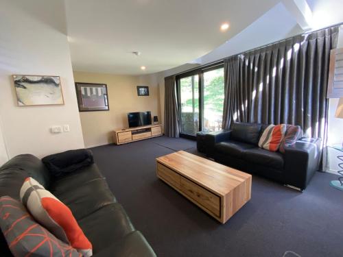 a living room with a couch and a coffee table at Oberdere 3 - Thredbo in Thredbo