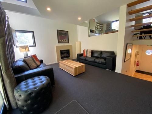 a living room with a couch and a table at Oberdere 3 - Thredbo in Thredbo