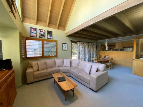 a living room with a couch and a table at Mitta Mitta - Thredbo in Thredbo