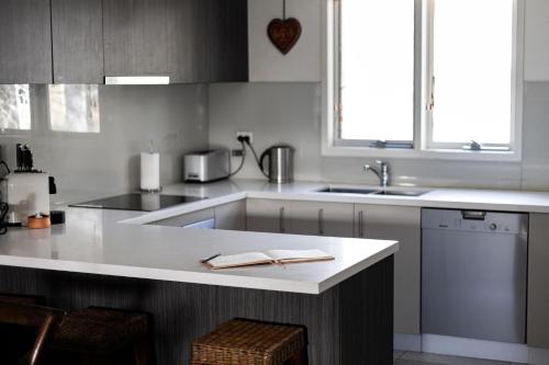 a kitchen with a white counter and a sink at Jagungal 2 - Thredbo in Thredbo