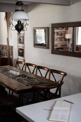 a dining room table with chairs and a mirror at Jagungal 2 - Thredbo in Thredbo