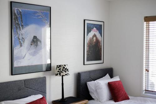 a bedroom with a bed and two pictures on the wall at Jagungal 2 - Thredbo in Thredbo