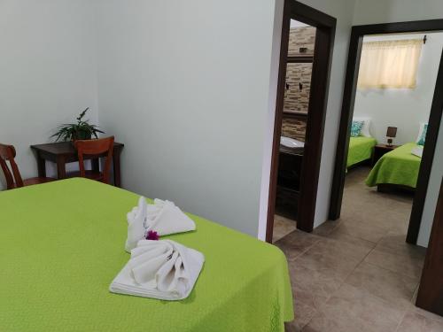 a room with a green table with towels on it at Hotel StarFish in Puerto Villamil