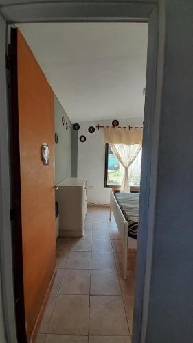 a hallway with a room with a bed and a window at Departamento Nini Villa Del Dique in Villa del Dique