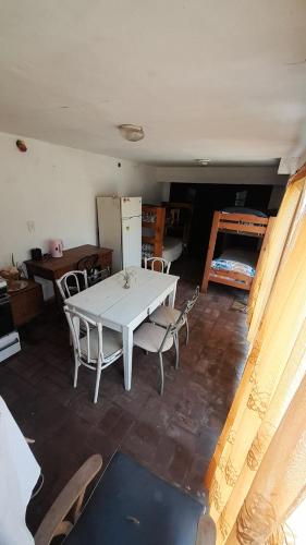 a room with a white table and chairs in it at Departamento Nini Villa Del Dique in Villa del Dique