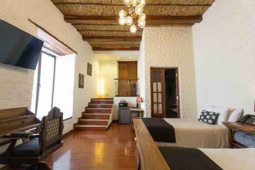 a large room with a bed and a staircase at On Hotel Boutique in Sucre