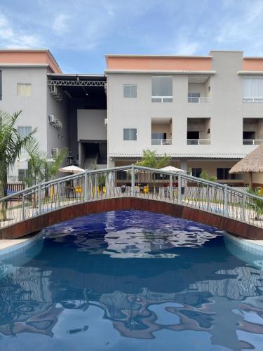 a bridge over a pool in front of a building at Flat em Alter do Chão in Alter do Chao