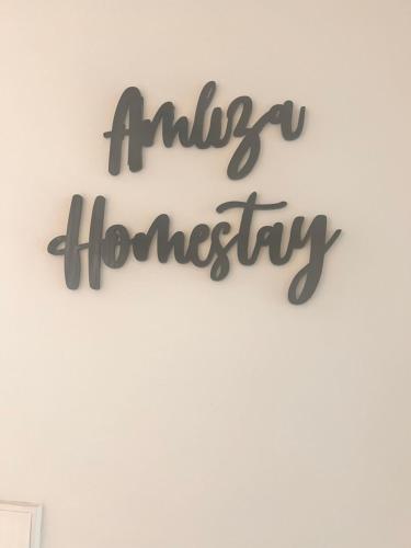a sign that reads antigua homesteadery hanging on a wall at Amliza homestay in Cyberjaya