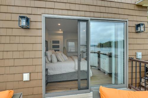 a bedroom with a bed on a balcony at Lake Winnipesaukee Condo with Beach Access! in Gilford
