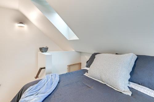 a bedroom with a blue bed with a pillow at Lake Winnipesaukee Condo with Beach Access! in Gilford