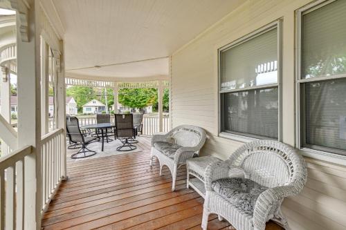 a porch with wicker chairs and a table and chairs at Lake Winnipesaukee Condo with Beach Access! in Gilford