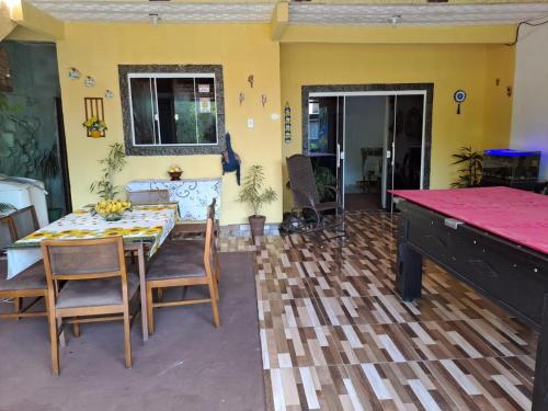 a dining room with a table and chairs at Pousada recanto do sabiá in Mangaratiba