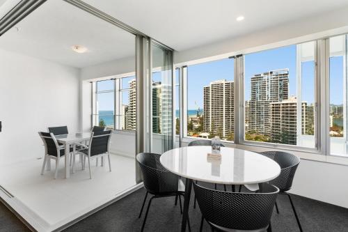a room with a table and chairs and windows at Q1 Resort & Spa - Official in Gold Coast