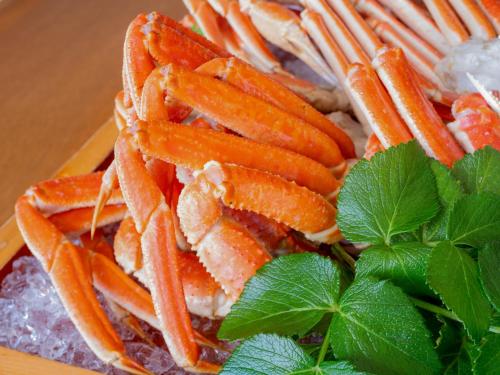 a pile of carrots on a plate with green leaves at REBUN Hotel SARYO in Kafuka