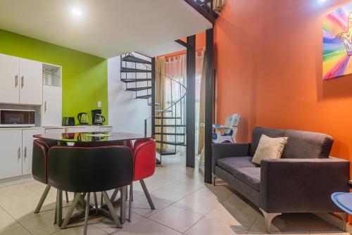 a kitchen and living room with a couch and a table at Cancún Suites Apartments - Hotel Zone in Cancún