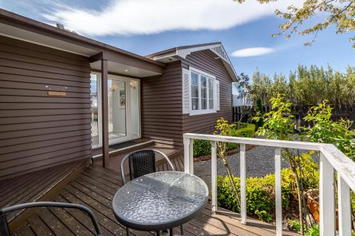a patio with a table and chairs on a deck at Bronte House in Martinborough 