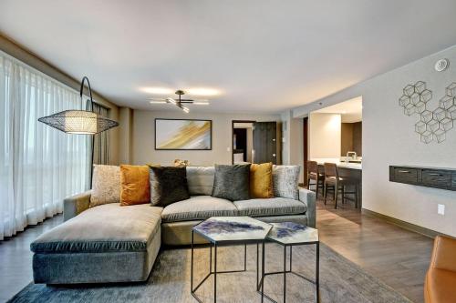 a living room with a couch and a table at Tulsa Marriott Southern Hills in Tulsa