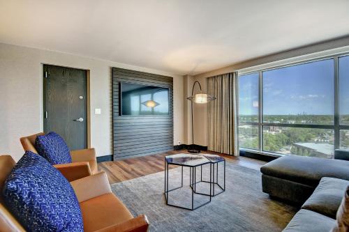 a living room with a couch and a table at Tulsa Marriott Southern Hills in Tulsa