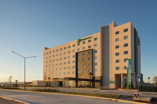 a large building on the side of a street at Holiday Inn & Suites - Aguascalientes by IHG in Aguascalientes