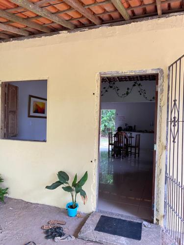 an open door of a house with a potted plant at Casa na floresta cósmica in Ananindeua