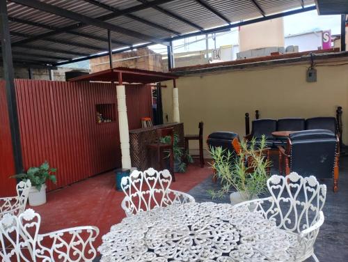 a patio with a white table and chairs at Royal Palace Hostal in Panajachel