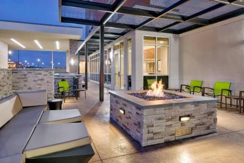 a fireplace in a patio with a fire pit at Springhill Suites by Marriott Colorado Springs North/Air Force Academy in Colorado Springs
