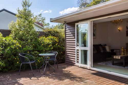 a patio with chairs and a table on a deck at Bronte House in Martinborough 