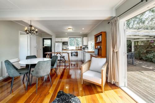a kitchen and dining room with a table and chairs at Bronte House in Martinborough 