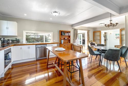 a kitchen and dining room with a table and chairs at Bronte House in Martinborough 