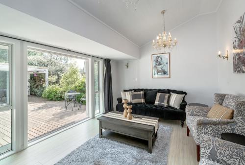 a living room with a couch and a table at Bronte House in Martinborough 