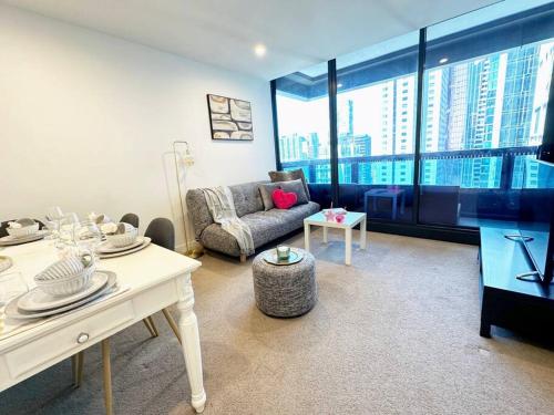 a living room with a couch and a table at ES2410-2Bed 2Bath Vision Apt with Balcony, Pool & Gym in Melbourne