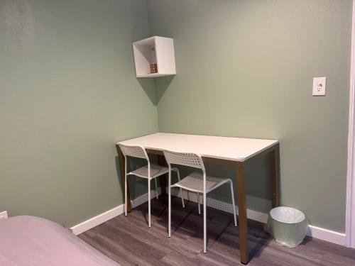 a small table and two chairs in a room at Garden Suite Two Bedroom with Hot Tub Sauna Outdoor kitchen and Game Room in Everett