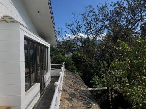 a balcony of a house with a view of the mountains at Ghost Villa Pokhara with mountain view 20mins from main area in Rānīpauwa