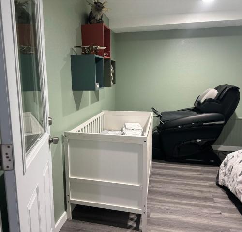 a bedroom with a black leather chair and a table at Garden Suite Two Bedroom with Hot Tub Sauna Outdoor kitchen and Game Room in Everett