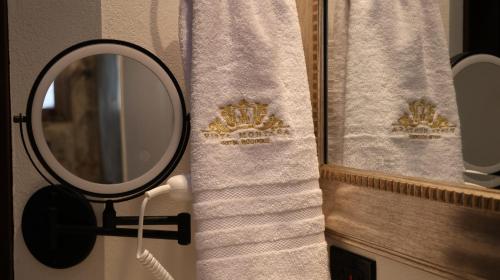 a bathroom with a mirror and a shower curtain at Hotel Vista Montaña in Villa de Leyva