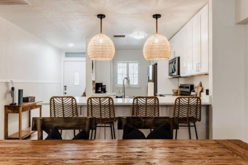 a kitchen with a wooden table and chairs at Catch the Breeze on Crystal Beach in Palm Harbor