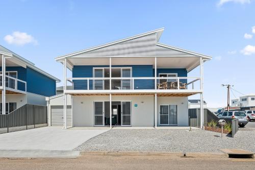 a blue and white house with a parking lot at C-Views - Aldinga Beach - C21 SouthCoast Holidays in Aldinga Beach