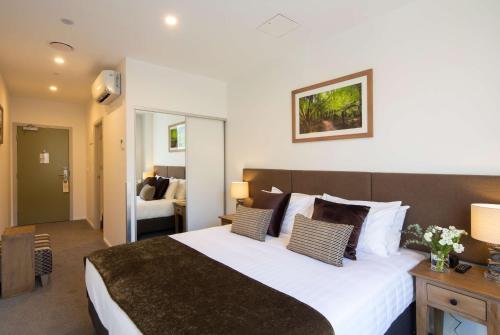 a bedroom with a large bed in a room at Wyndham Garden Remarkables Park Queenstown in Queenstown