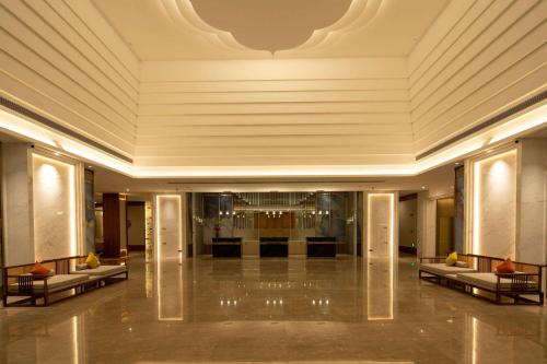 a lobby of a hotel with a large ceiling at Wingate by Wyndham Libo Center in Libo