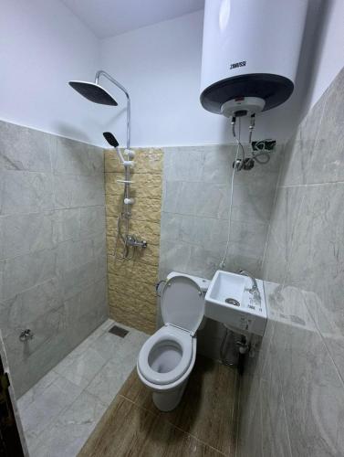 a bathroom with a shower and a toilet and a sink at Atlas appartement in Fez
