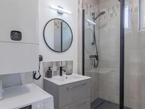 a bathroom with a sink and a shower with a mirror at Maison rénovée avec jardin proche d'Angers - FR-1-622-92 in Rochefort-sur-Loire