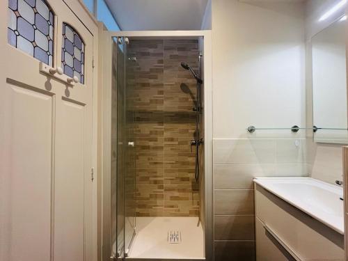 a bathroom with a shower and a sink at Charmant studio au centre du Mont-Dore, bien équipé, max 2 pers - FR-1-608-273 in Mont-Dore